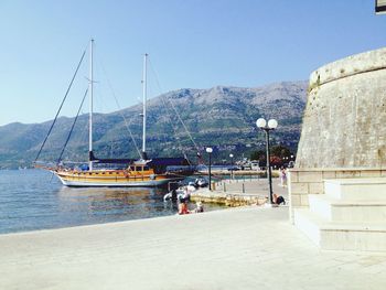 Sailing ship moored at harbor in adriatic sea against clear sky