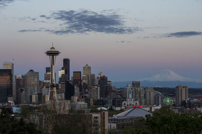 View of cityscape against cloudy sky