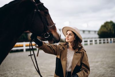 Young woman wearing hat standing outdoors