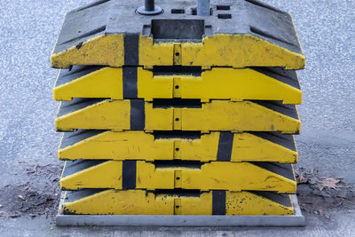 Low angle view of yellow sign on wall