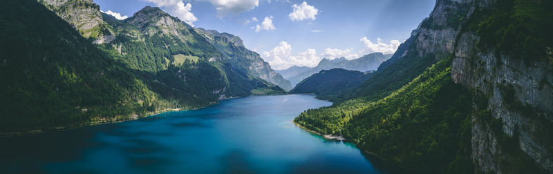 Panoramic view of river amidst mountains against sky