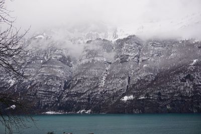 Scenic view of sea and mountains during winter