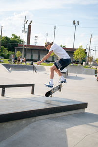 Low angle view of man jumping on built structure