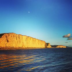 Scenic view of sea against clear blue sky