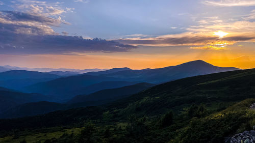 Scenic view of mountains against sky during sunset