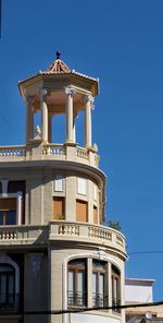 Low angle view of building against clear blue sky