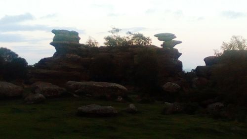 Rocks on landscape against sky