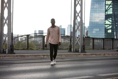 Portrait of young man walking on road