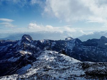 Scenic view of snowcapped mountains against sky