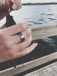 Close-up of woman holding hands over water