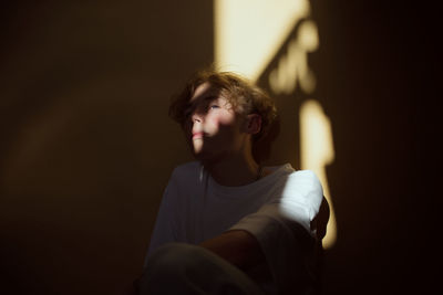 Portrait of young man sitting at home