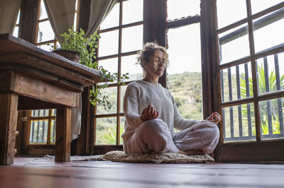 Low angle view of woman sitting at home