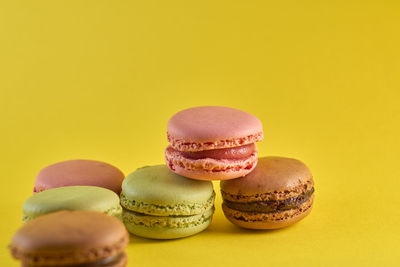 Close-up of multi colored candies against yellow background