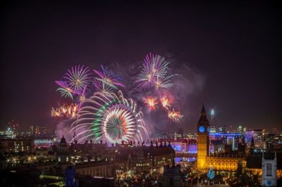 Low angle view of firework display at night