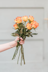 Cropped hand of woman holding flower