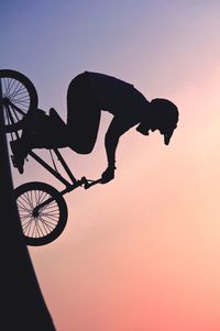 Bmx biker against sunset