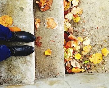Low section of people standing on tiled floor