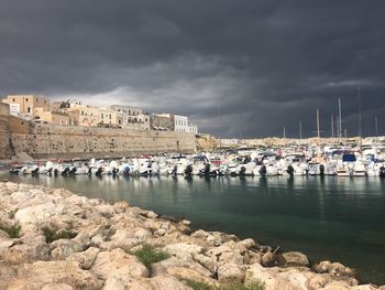 Sailboats in sea against sky