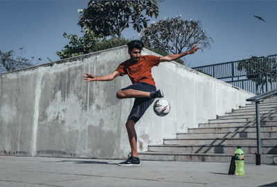 Full length of man on wall against sky