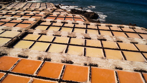 High angle view of salt flat sea salk farm water fields multicolour texture background 