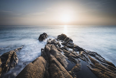 Scenic view of sea against sky during sunset