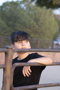 Portrait of handsome boy focused looking at sunset. teenager with thoughtful expression relaxed