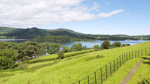 Scenic view of green landscape against sky