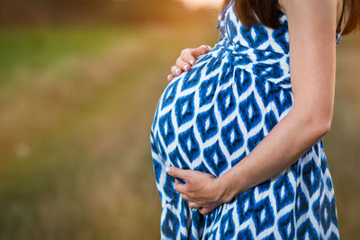 Close-up mid section of woman standing