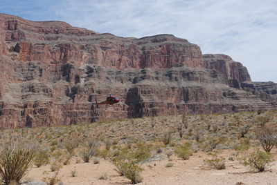 Rock formations on landscape against sky