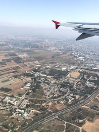 Aerial view of airplane flying over city