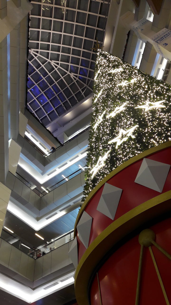 LOW ANGLE VIEW OF ILLUMINATED BUILT STRUCTURES