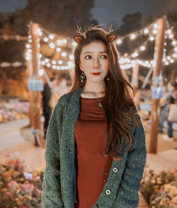 Portrait of beautiful young woman standing outdoors