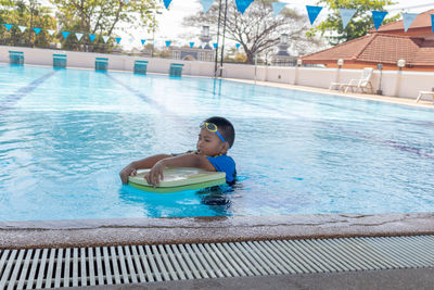 Portrait of boy swimming in pool