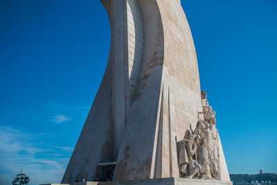 Low angle view of sculpture against blue sky