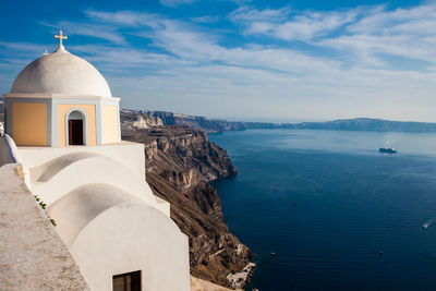 The aegean sea and the catholic church of st. stylianos in the city of fira in santorini island