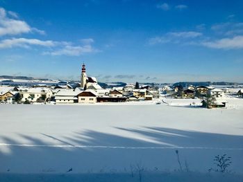 Snow covered landscape against sky