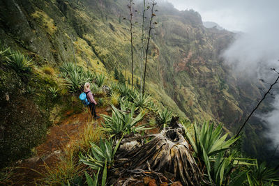 Female traveler staying on the cove volcano edge. santo antao island in cabo verde