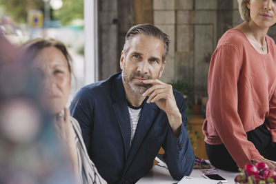 Businessman looking at colleague giving presentation in portable office truck