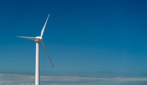 Low angle view of wind turbine against sky