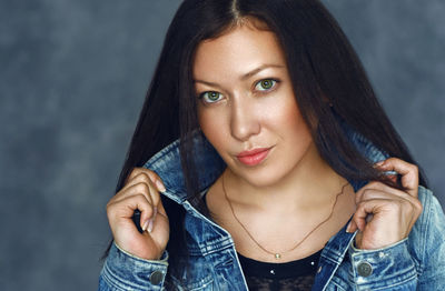 Portrait of beautiful young woman wearing denim jacket