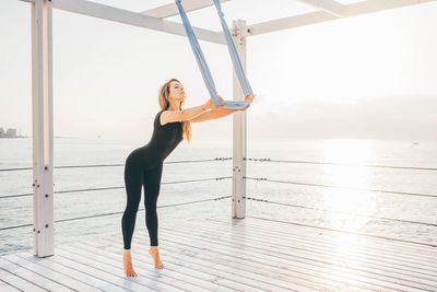 Full length of woman exercising in gym