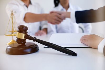 Cropped image of lawyer shaking hands with colleague