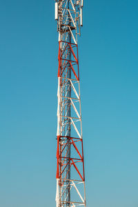 Low angle view of crane against clear blue sky