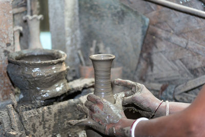 Cropped image of hands making pottery