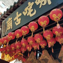 Low angle view of lanterns hanging on wall