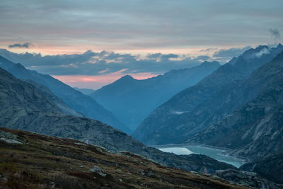 Scenic view of snowcapped mountains against sky during sunset