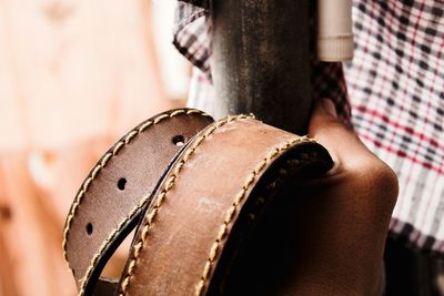 Close-up of man holding belt