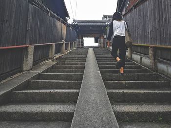 Low section of man walking on staircase