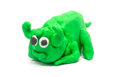 Close-up of green toy against white background