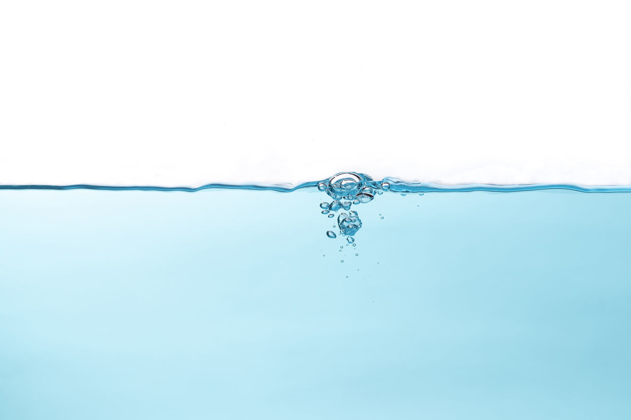 CLOSE-UP OF WATER DROP AGAINST BLUE BACKGROUND